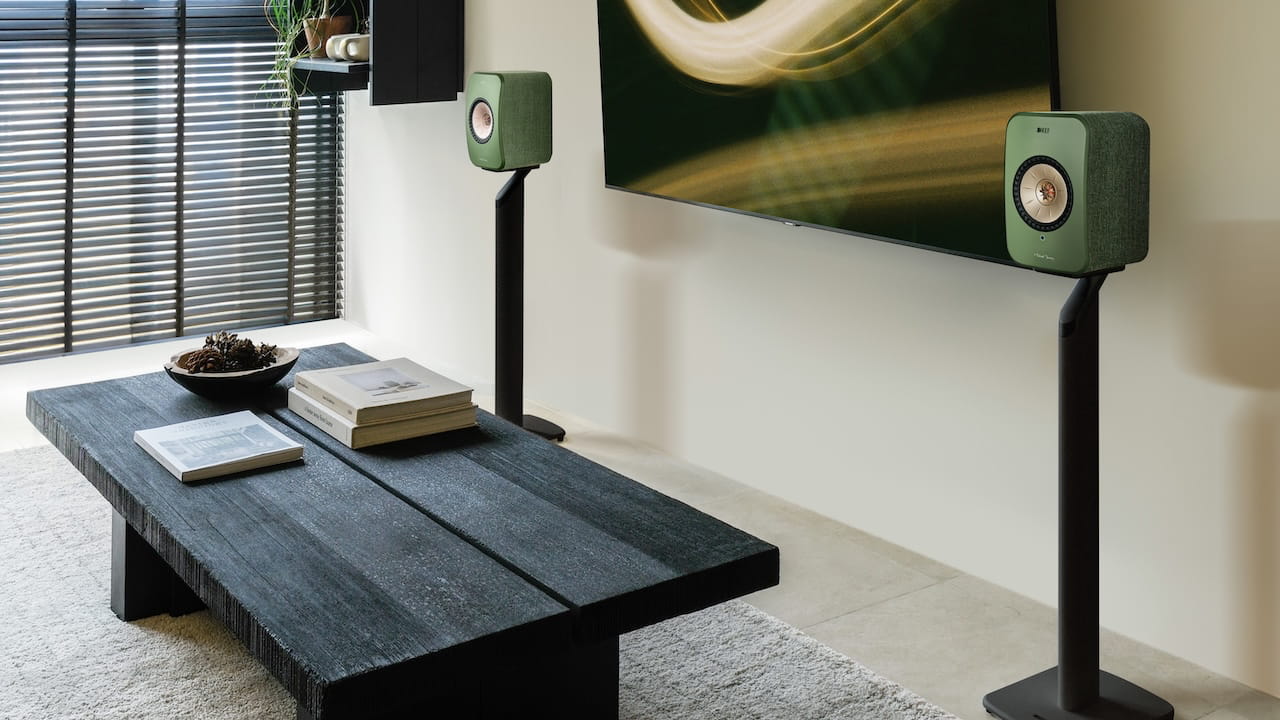 KEF LSX II Wireless Loudspeakers in Olive Green on stands in living room