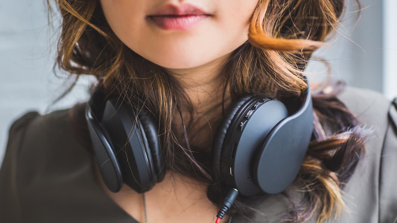 Millennial Woman with Headphones Around Neck