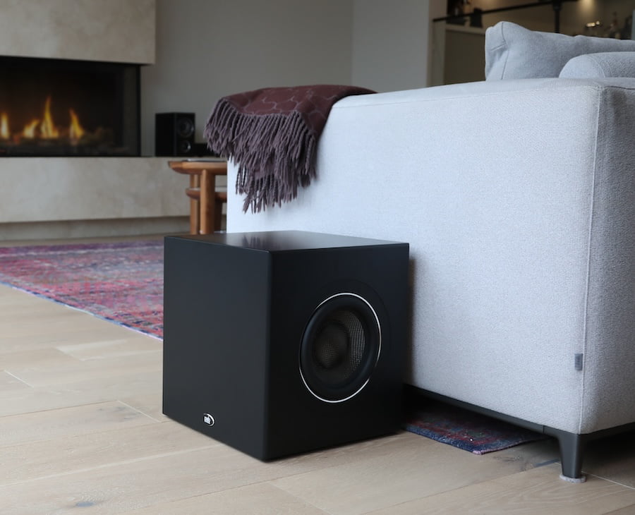 PSB Speakers SubSeries BP8 Powered Subwoofer Black Next to Couch